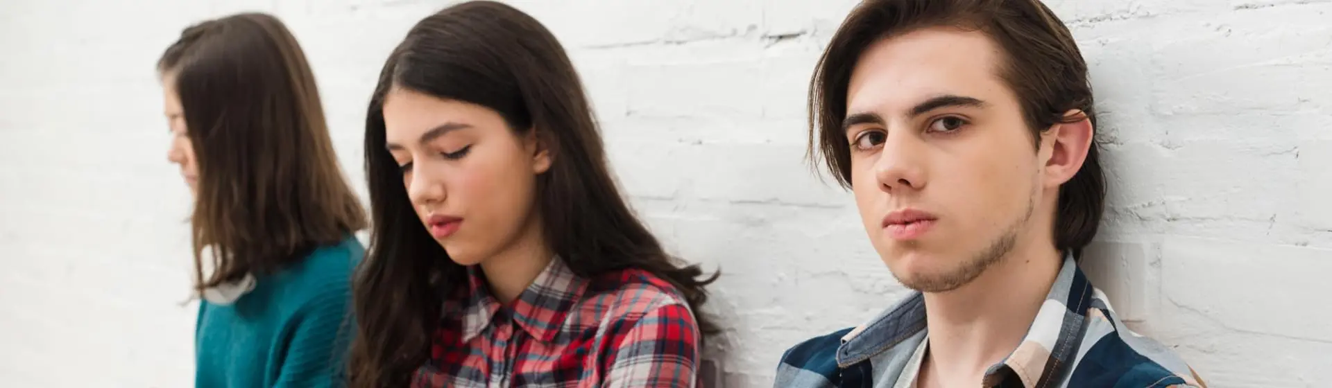 A group of teens sitting together.